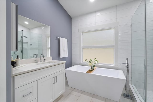 bathroom with vanity, separate shower and tub, and tile patterned flooring