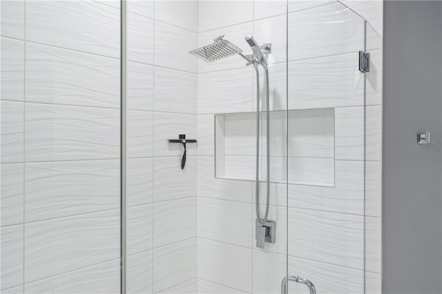 bathroom featuring a shower with shower door