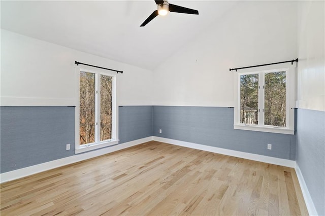 unfurnished room featuring ceiling fan, light wood-type flooring, and high vaulted ceiling