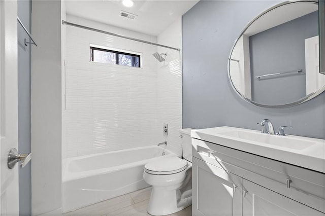 full bathroom featuring toilet, vanity, and tiled shower / bath combo