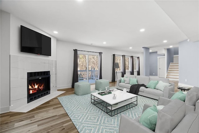 living room with hardwood / wood-style floors and a fireplace