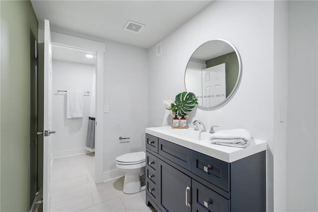 bathroom featuring toilet and vanity