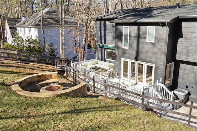 exterior space with a fire pit and a lawn