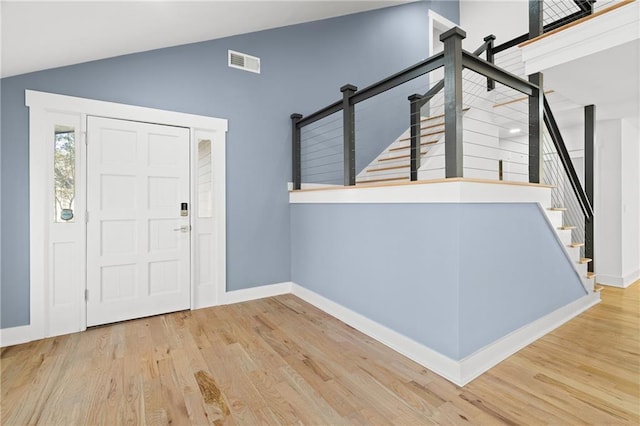 entryway featuring light wood-type flooring and lofted ceiling