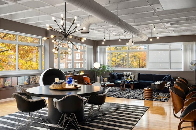 sunroom / solarium with a chandelier