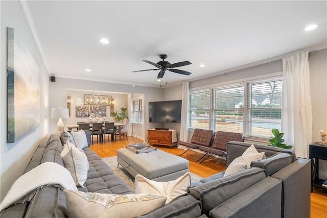 living room featuring ornamental molding, ceiling fan, and light hardwood / wood-style floors