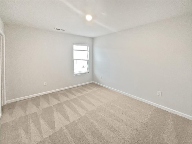 empty room with light carpet, baseboards, and visible vents