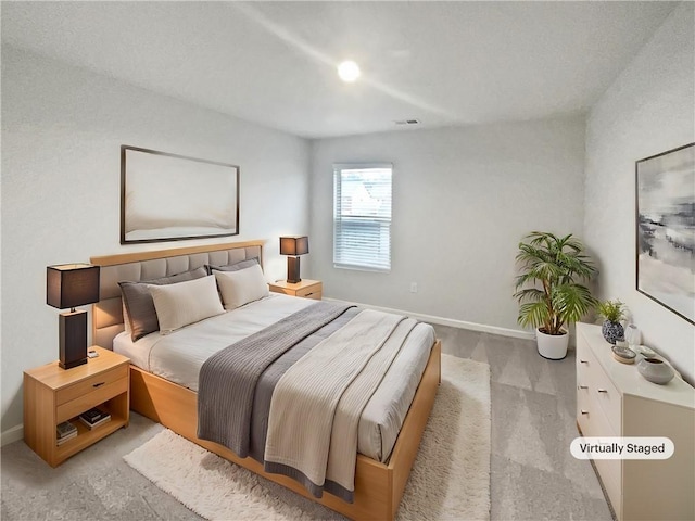 bedroom with visible vents, light colored carpet, and baseboards