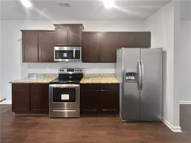 kitchen featuring dark brown cabinetry, visible vents, baseboards, dark wood-style floors, and appliances with stainless steel finishes