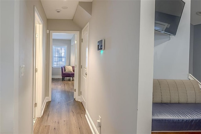 hallway with light hardwood / wood-style floors