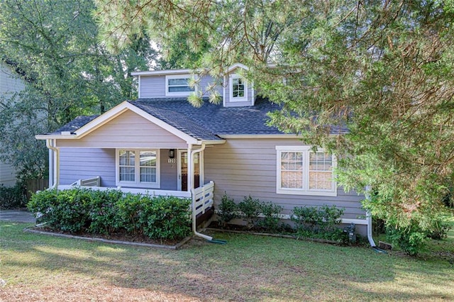 view of front of property with covered porch and a front yard