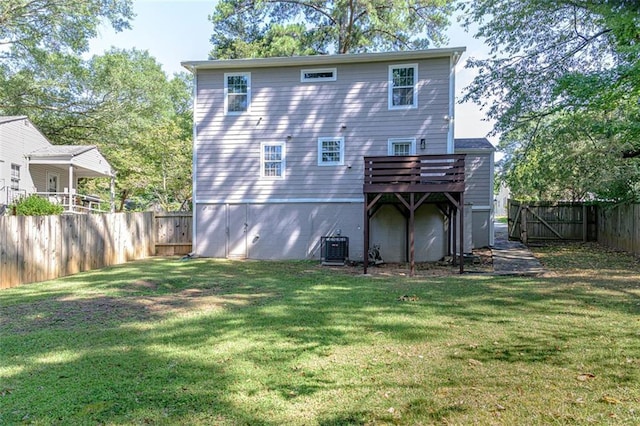 back of house with a wooden deck, a yard, and central AC unit