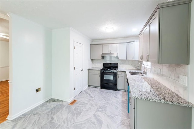 kitchen featuring sink, light stone counters, black range with gas cooktop, and gray cabinets