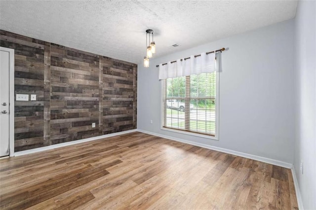 5375 Mountain View Pkwy, Lula, GA 30554 - spare room featuring wood finished floors, a textured ceiling, and wooden walls