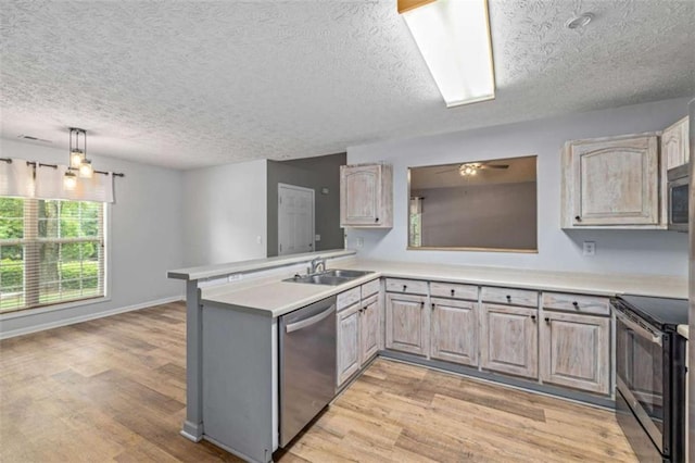 5375 Mountain View Pkwy, Lula, GA 30554 - kitchen featuring appliances with stainless steel finishes, a textured ceiling, light wood-type flooring, light countertops, and a peninsula