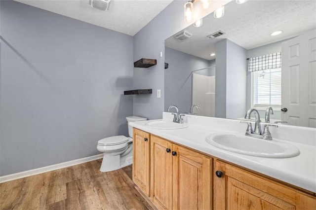5375 Mountain View Pkwy, Lula, GA 30554 - bathroom featuring double vanity, wood finished floors, a shower, and a textured ceiling