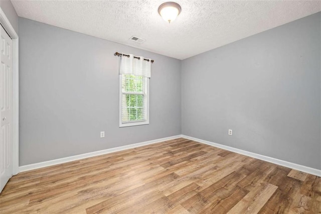 5375 Mountain View Pkwy, Lula, GA 30554 - unfurnished bedroom with light wood-style flooring, a closet, and a textured ceiling