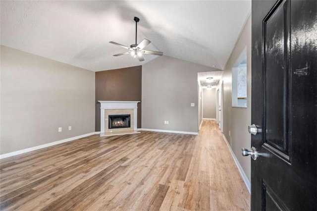 5375 Mountain View Pkwy, Lula, GA 30554 - unfurnished living room featuring ceiling fan, lofted ceiling, light wood-style flooring, and a fireplace with flush hearth