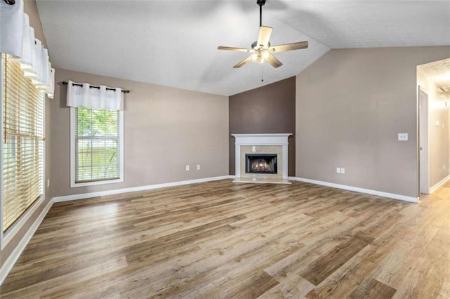 5375 Mountain View Pkwy, Lula, GA 30554 - unfurnished living room featuring vaulted ceiling, wood finished floors, a ceiling fan, and a high end fireplace