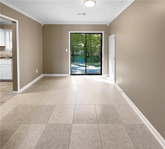 tiled empty room featuring crown molding and sink