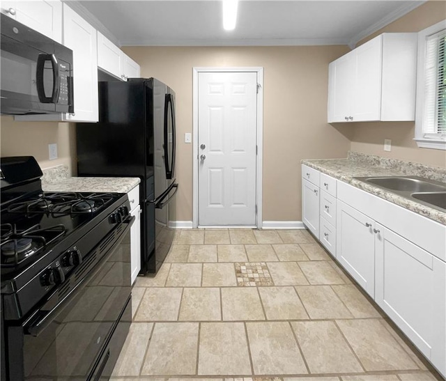 kitchen featuring light stone countertops, black appliances, white cabinets, and crown molding