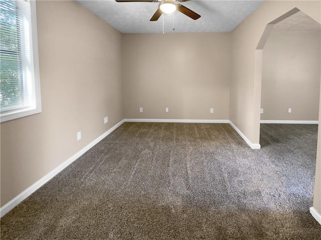 carpeted spare room with ceiling fan and a textured ceiling