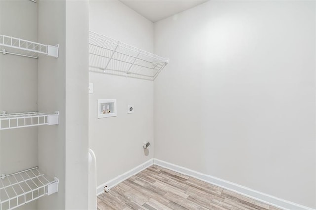 clothes washing area with electric dryer hookup, washer hookup, and light wood-type flooring