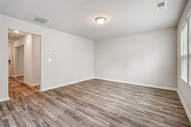 empty room with hardwood / wood-style floors