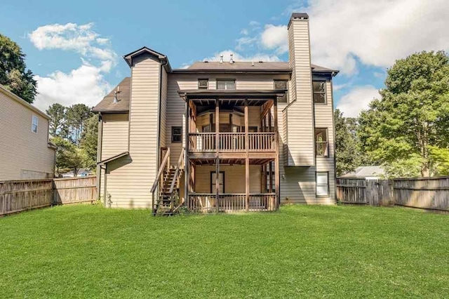 rear view of house featuring a lawn