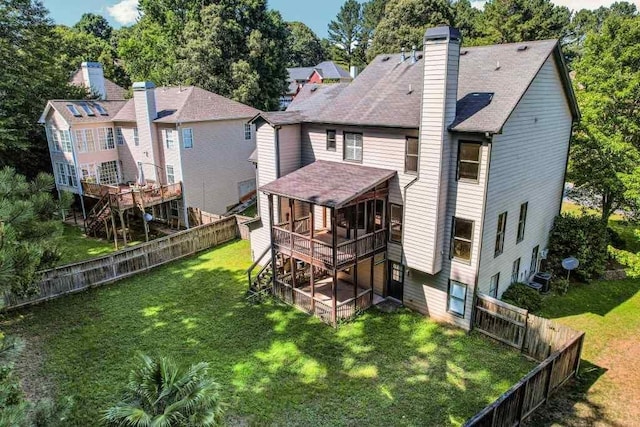 rear view of property featuring a wooden deck and a yard