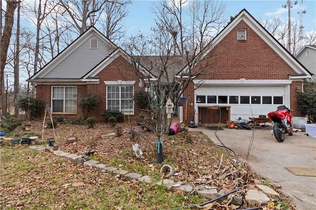 ranch-style house featuring a garage, driveway, and brick siding