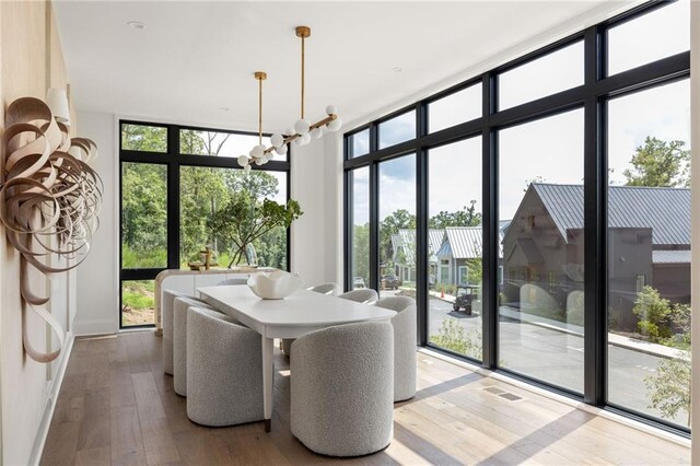 sunroom featuring an inviting chandelier