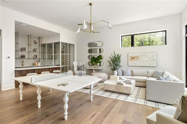 living room featuring a chandelier, light hardwood / wood-style flooring, and a healthy amount of sunlight