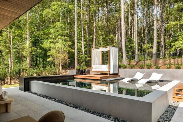 view of patio / terrace with a fenced in pool