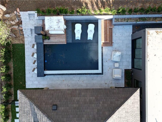 view of patio with an outdoor living space with a fireplace, ceiling fan, and a pool