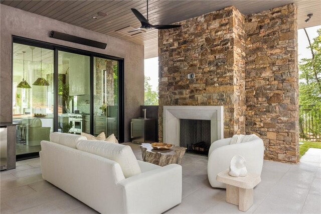 sunroom / solarium featuring wooden ceiling and an outdoor stone fireplace