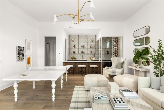 bar with hardwood / wood-style floors, sink, and tasteful backsplash