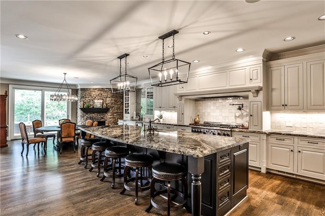 kitchen with a breakfast bar area, recessed lighting, a notable chandelier, and tasteful backsplash