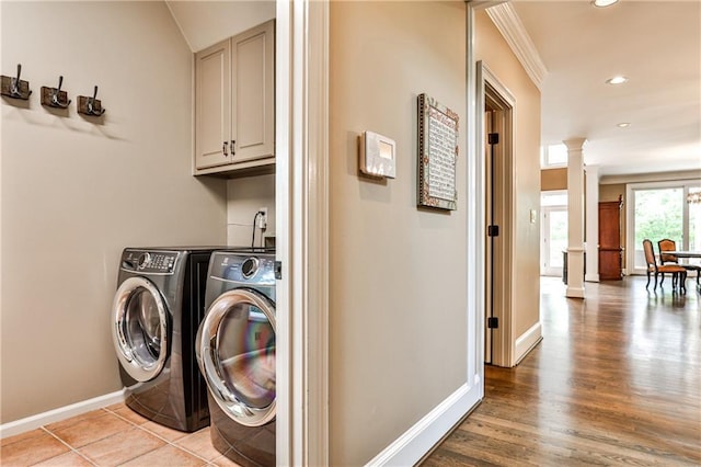 washroom with washing machine and dryer, baseboards, ornate columns, recessed lighting, and cabinet space