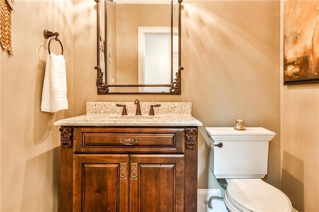half bath featuring vanity and toilet
