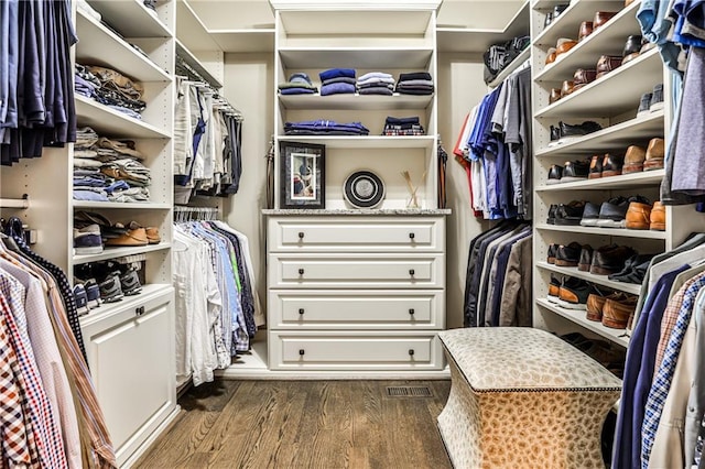 spacious closet with dark wood-style flooring