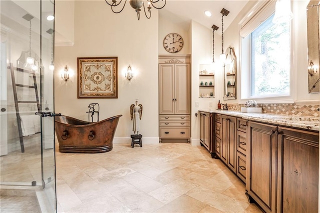 bathroom featuring vanity, plenty of natural light, a soaking tub, and a shower stall