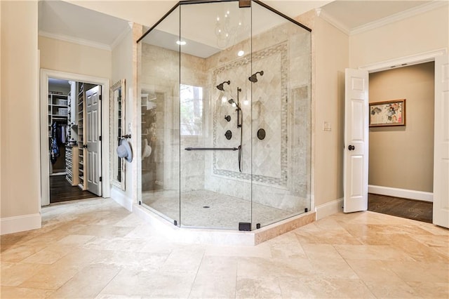 full bath with baseboards, ornamental molding, and a stall shower