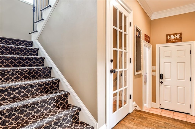 interior space featuring baseboards, ornamental molding, and wood finished floors