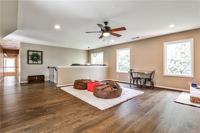 living area featuring dark wood-type flooring, recessed lighting, ceiling fan, and visible vents