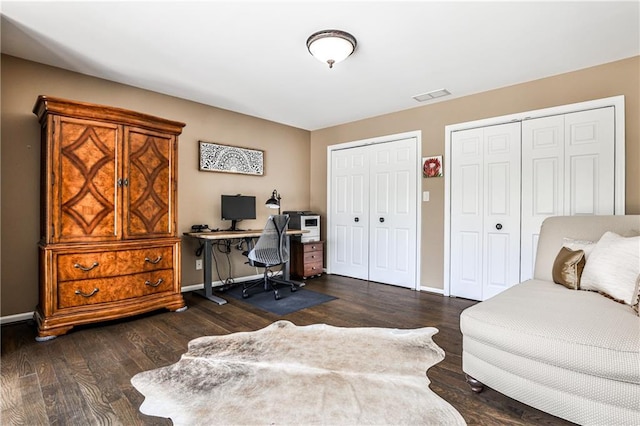 office area featuring baseboards, wood finished floors, and visible vents