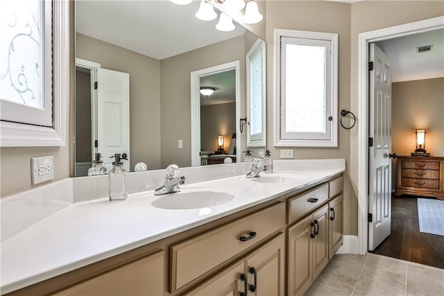 full bath with visible vents, a sink, connected bathroom, and double vanity