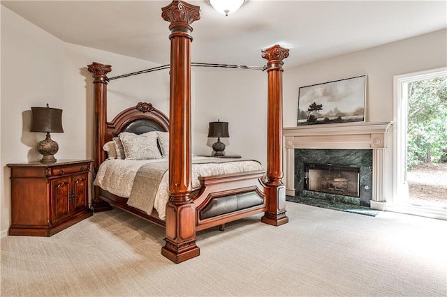 carpeted bedroom featuring access to outside and a high end fireplace