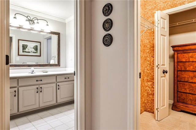 bathroom featuring crown molding, tile patterned floors, and vanity