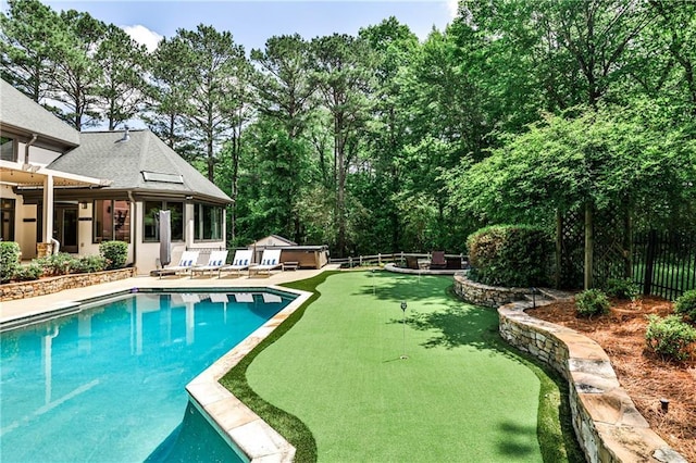 pool featuring a patio, a fenced backyard, and an outdoor structure
